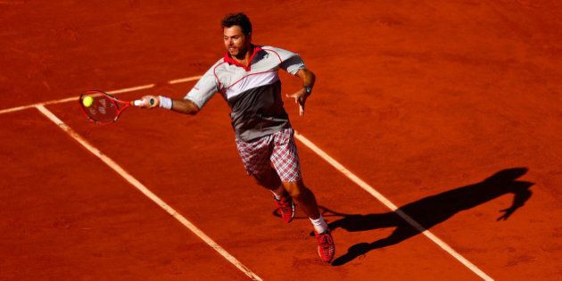PARIS, FRANCE - JUNE 07: Stanislas Wawrinka of Switzerland returns a shot in the Men's Singles Final against Novak Djokovic of Serbia on day fifteen of the 2015 French Open at Roland Garros on June 7, 2015 in Paris, France. (Photo by Julian Finney/Getty Images)