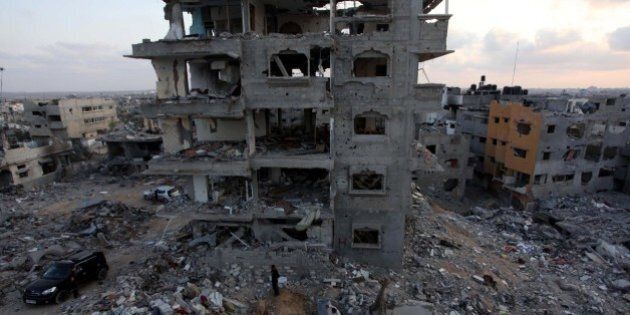 GAZA CITY, GAZA - AUGUST 18 : Palestinians live among the debris of buildings destroyed in Israeli shelling in Al Shaaf neighborhood of Gaza City, Gaza on August 18, 2014. (Photo by Ashraf Amra/Anadolu Agency/Getty Images)