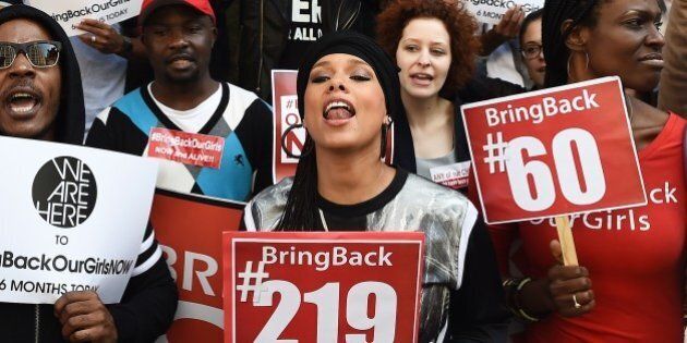 US singer-songwriter Alicia Keys (C) shouts slogans as she joins protesters with the 'Bring Back Our Girls' campaign during a demonstration in front of the Nigerian consulate in New York on October 14, 2014, to mark the six month anniversary of the kidnapping of over 200 Nigerian schoolgirls by Boko Haram militants. Six months since the kidnapping of the teenagers, interest in their plight has waned despite an initial wave of international outrage. AFP PHOTO/Jewel Samad (Photo credit should read JEWEL SAMAD/AFP/Getty Images)
