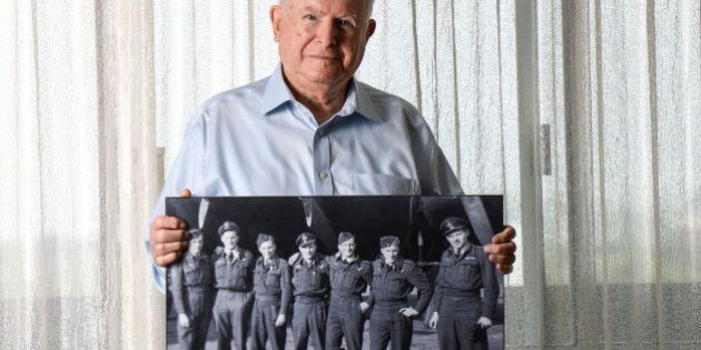 TORONTO, ON - AUGUST 25: TORONTO, ON - Nathan Isaacs, a 90-year-old WWII veteran who flew 35 missions as a navigator in the bomber command poses for a portrait holding a photo of his crew whom he worked with for all 35 missions. (CREW PHOTO L-R -Bill Lossing of Windsor ON, Al Horton of Humboldt SK, Tom Leaver of Toronto ON, Nathan Issaacs of Toronto ON, John Tribe of Alymer ON, Derald Brinkley of Gloucester UK and John Mulholland of Mitchell ON.) More than 70 years later, the Canadian government is honouring those who served in the Bomber Command with special bars in commemoration of their service. Sunday August 25, 2013 Tara Walton/Toronto Star (Tara Walton/Toronto Star via Getty Images)