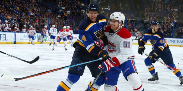 ST. LOUIS, MO - FEBRUARY 24: Carl Gunnarsson #4 of the St. Louis Blues looks to keep Lars Eller #81 of the Montreal Canadiens away from a loose puck t the Scottrade Center on February 24, 2015 in St. Louis, Missouri. (Photo by Dilip Vishwanat/NHLI via Getty Images)