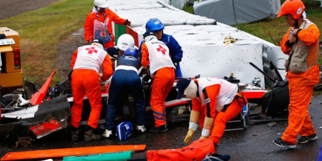 SUZUKA, JAPAN - OCTOBER 05: Jules Bianchi of France and Marussia receives urgent medical treatment after crashing during the Japanese Formula One Grand Prix at Suzuka Circuit on October 5, 2014 in Suzuka, Japan. (Photo by Getty Images/Getty Images)
