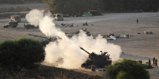 An Israeli tank fires a 155mm shell towards targets in the Gaza Strip from their position near Israel's border with the Palestinian enclave on July 23, 2014. The UN Human Rights Council on Wednesday launched a probe into the Gaza offensive, backing calls by the Palestinians to hold Israel to account despite fierce opposition from the Jewish state. The decision came after a marathon seven-hour emergency session of the top UN human rights body, where the Israelis and the Palestinians traded accusations over war crimes. AFP PHOTO / DAVID BUIMOVITCH (Photo credit should read DAVID BUIMOVITCH/AFP/Getty Images)