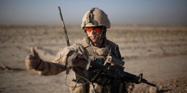 Pvt. Kevin Tessier, 20, of Montreal, Canada, with the Canadian Army's 1st Battalion Royal 22nd Regiment signals during an operation Wednesday, June 29, 2011 in the Panjwaii district of Kandahar province, Afghanistan. Canadian combat operations will end in July as troops withdraw from the southern region and hand control over to the Americans. Canada will transition to a non-combat training role with up to 950 soldiers and support staff to train Afghan soldiers and cops in areas of the north, west and Kabul. (AP Photo/David Goldman)