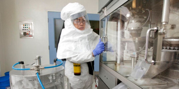 A worker monitors machines that produce tablets at the Apotex Inc. plant in Toronto, Ontario, Canada, on Wednesday, Nov. 3, 2011. Apotex Inc., a manufacturer of generic drugs, agreed to delay selling a generic version of the osteoporosis drug Boniva until a judge rules on the validity of a Roche Holding AG patent on the medicine that expires in March 2012. Photographer: Norm Betts/Bloomberg via Getty Images