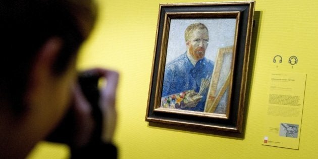 A visitor in the Van Gogh Museum Amsterdam takes a picture of the famous Dutch painter's self portrait with easel dated from 1888 prior to the reopening of the museum, in Amsterdam on May 1, 2013. According to media information the museum was renovated for several months with more than 10,000 square meters of walls painted and about 2,300 square meters of parquet floor laid. Amsterdam's Van Gogh Museum reopened its doors to the public with a stunning new display of some of the Dutch master's greatest works, completing a trio of renovations of the city's most famous museums. AFP PHOTO / ANP -KOEN VAN WEEL = netherlands out RESTRICTED TO EDITORIAL USE, MANDATORY CREDIT OF THE ARTIST, TO ILLUSTRATE THE EVENT AS SPECIFIED IN THE CAPTION (Photo credit should read Koen van Weel/AFP/Getty Images)