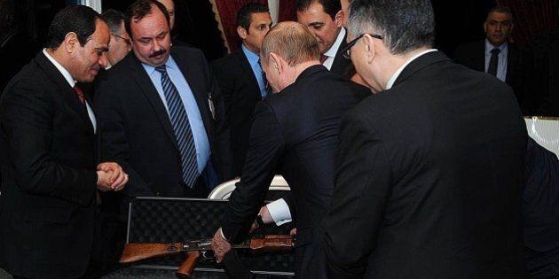 CAIRO, EGYPT - FEBRUARY 9: Russian President Vladimir Putin (2nd R) gives an AK47 rifle as a gift to Egyptian President Abdel Fattah el-Sisi (L) during an informal dinner in honor of Putin at Cairo Tower on February 9, 2015 in Cairo, Egypt. (Photo by Pool / MENA/Anadolu Agency/Getty Images)