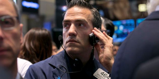 Trader Gregory Rowe works on the floor of the New York Stock Exchange, Thursday, Oct. 2, 2014. U.S. stocks fell for a fourth straight day Thursday, adding to big losses the day before, as energy companies dragged down the broader market. Investors also worked through a report that showed fewer Americans applied for unemployment benefits. (AP Photo/Richard Drew)