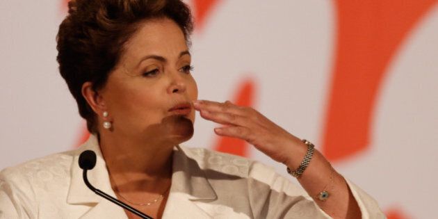 Brazil's President Dilma Rousseff, presidential candidate for re-election of the Workers Party,PT, blows a kiss during a press conference, in Brasilia, Brazil, Sunday, Oct. 5, 2014. Official results showed Sunday that President Dilma Rousseff will face challenger Aecio Neves in a second-round vote in Brazil's most unpredictable presidential election since the nation's return to democracy nearly three decades ago. (AP Photo/Eraldo Peres)