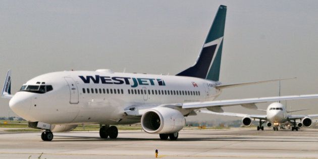 CANADA - JUNE 08: A WestJet plane taxi's on the runway of Pearson International Airport in Toronto, Ontario, Canada, Wednesday, June 8, 2005. (Photo by Norm Betts/Bloomberg via Getty Images)