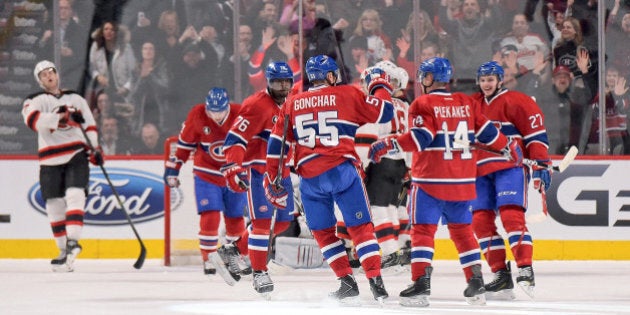 MONTREAL, QC - FEBRUARY 7: Tomas Plekanec #14 of the Montreal Canadiens celebrate with teammates after scoring a goal against the New Jersey Devils in the NHL game at the Bell Centre on February 7, 2015 in Montreal, Quebec, Canada. (Photo by Francois Lacasse/NHLI via Getty Images)