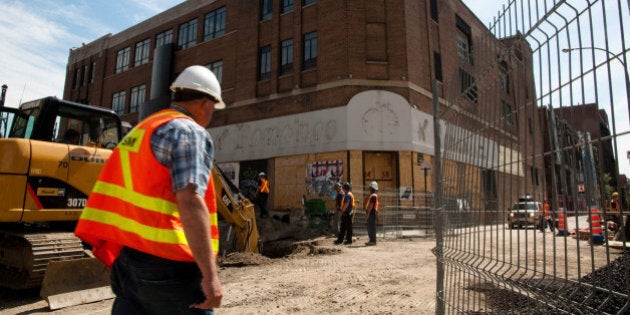 TO GO WITH AFP STORY CANADA-CULTURE-CABARET-SOCIETY Workers are seen May 18, 2010 on St. Catherine Street in Montreal, Quebec around the Red light district, as construction work continues. If the construction project of 'Quadrilatère Saint Laurent' leads, the buildings in the background will be destroyed. AFP PHOTO/UGO AMEZ (Photo credit should read UGO AMEZ/AFP/Getty Images)