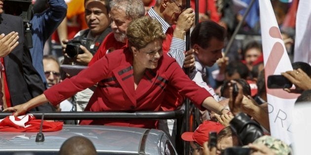 The Brazilian President and presidential candidate for the Workers' Party (PT) Dilma Rousseff greets supporters during a campaign rally in Sao Paulo Brazil on October 03, 2014. The Brazilian general elections will take place next October 5. AFP PHOTO / Miguel SCHINCARIOL (Photo credit should read Miguel Schincariol/AFP/Getty Images)