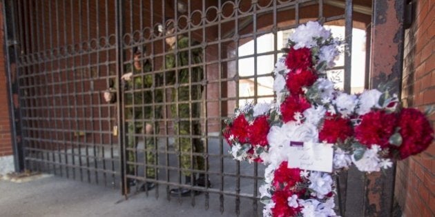 Soldiers lock the gates at the John Weir Foote V.C. Armouries in Hamilton, Ontario, October 22, 2014 after a soldier believed to be from the base was killed in an attack in Ottawa. A gunman whose name was on a terror watch list killed a soldier and attempted to storm Canada's parliament before being gunned down in turn by the assembly's sergeant-at-arms. AFP PHOTO / Geoff ROBINS (Photo credit should read GEOFF ROBINS/AFP/Getty Images)