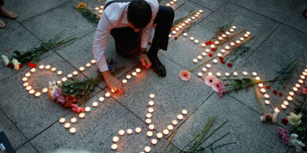KUALA LUMPUR, MALAYSIA - JULY 21: An Ukranian man lights up candles during a candle light vigil for the victims of MH17 on July 21, 2014 in Kuala Lumpur, Malaysia. Malaysian Airlines flight MH17 was travelling from Amsterdam to Kuala Lumpur when it crashed killing all 298 on board including 80 children. The aircraft was allegedly shot down by a missile and investigations continue over the perpetrators of the attack. (Photo by Rahman Roslan/Getty Images)