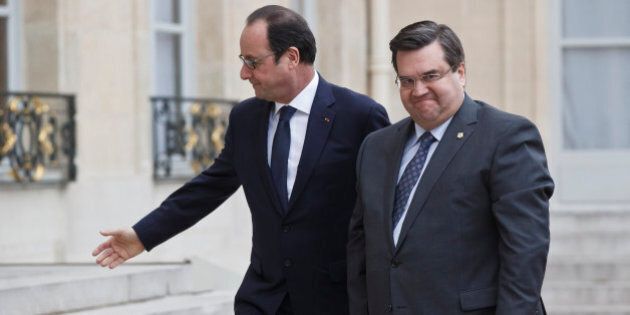 French President Francois Hollande, left, welcomes Montreal Mayor Denis Coderre, right, at the Elysee Palace in Paris, Monday Feb. 2, 2015. Coderre arrived for a three-days visit in France. (AP Photo/Michel Euler)