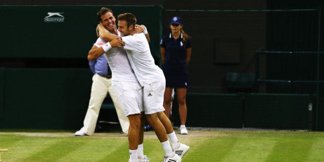 LONDON, ENGLAND - JULY 05: Vasek Pospisil of Canada (l) and Jack Sock of the United States celebrate after winning the Gentlemen's Doubles Final against Bob Bryan and Mike Bryan of the United States on day twelve of the Wimbledon Lawn Tennis Championships at the All England Lawn Tennis and Croquet Club on July 5, 2014 in London, England. (Photo by Al Bello/Getty Images)