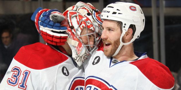 NEW YORK, NY - JANUARY 29: Carey Price #31 and Brandon Prust #8 of the Montreal Canadiens celebrate after a 1-0 win over the New York Rangers at Madison Square Garden on January 29, 2015 in New York City. (Photo by Jared Silber/NHLI via Getty Images)