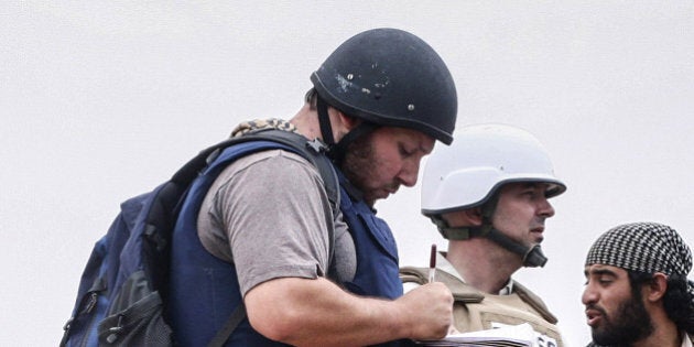 MISRATA, LIBYA - JUNE 02: In this handout image made available by the photographer American journalist Steven Sotloff (Center with black helmet) talks to Libyan rebels on the Al Dafniya front line, 25 km west of Misrata on June 02, 2011 in Misrata, Libya. Sotloff was kidnapped in August 2013 near Aleppo, Syria and was recently shown on a jihadist video in which fellow US journalist James Foley was executed. In the video the militant form the Islamic State (IS) threatens to kill Sotloff next if the US continues its aerial campaign against the insurgency. (Photo by Etienne de Malglaive via Getty Images)