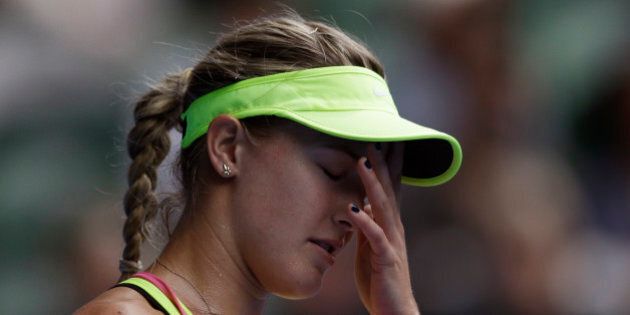 Eugenie Bouchard of Canada reacts as she plays Maria Sharapova of Russia during their quarterfinal match at the Australian Open tennis championship in Melbourne, Australia, Tuesday, Jan. 27, 2015. (AP Photo/Bernat Armangue)
