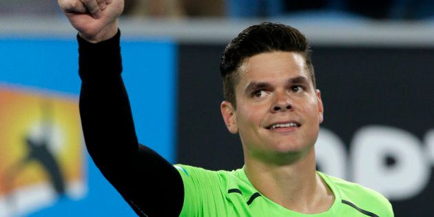 Milos Raonic of Canada celebrates after defeating Donald Young of the U.S. during their second round match at the Australian Open tennis championship in Melbourne, Australia, Thursday, Jan. 22, 2015. (AP Photo/Lee Jin-man)
