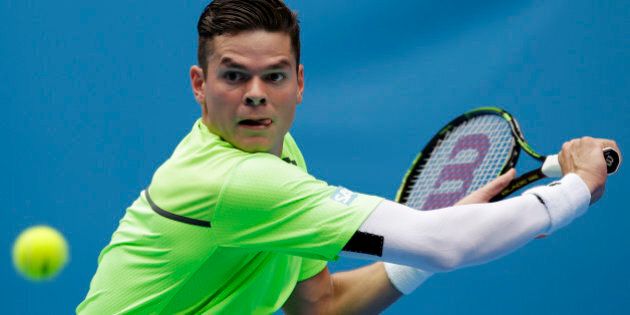Milos Raonic of Canada eyes on the ball for a shot to Illya Marchenko of Ukraine during their first round match at the Australian Open tennis championship in Melbourne, Australia, Tuesday, Jan. 20, 2015. (AP Photo/Bernat Armangue)