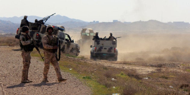 DIYALA, IRAQ - JANUARY 22: Iraqi security forces are seen during a military operation launched by the Iraqi army to retake positions held by Islamic State of Iraq and the Levant (ISIL) militants near the village of Sharween, in Diyala province, Iraq on January 22 2015. Iraqi army regained the controls of Sharween, ed-Dewalib, Arab Samer, Nejm al-Abdallah, Taha al-Ulwan and Mansuriya al Jabal villages from ISIL militants. (Photo by Stringer/Anadolu Agency/Getty Images)