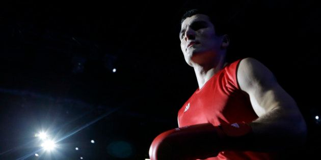 Russia's Artur Beterbiev arrives for his fight against the United States' Michael Hunter II (blue) during a heavyweight 91-kg preliminary boxing match at the 2012 Summer Olympics, Wednesday, Aug. 1, 2012, in London. (AP Photo/Patrick Semansky)