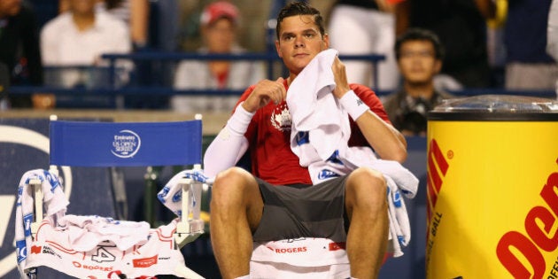 TORONTO, ON - AUGUST 08: Milos Raonic of Canada rests between games against Feliciano Lopez of Spain in the quarterfinals during Rogers Cup at Rexall Centre at York University on August 8, 2014 in Toronto, Canada. (Photo by Ronald Martinez/Getty Images)