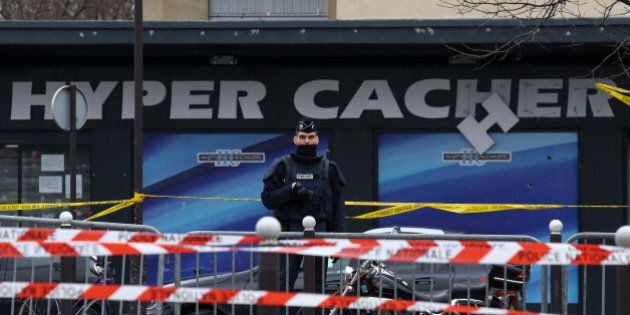PARIS, FRANCE - JANUARY 10: Police officers guard the kosher market 'Hyper Cacher', which suffered a terrorist attack yesterday, on January 10, 2015 in Paris, France. Four hostages and three suspects were killed when police ended two separate sieges at a kosher supermarket and a printing company on an industrial estate, following Wednesday's deadly attack on 'Charlie Hebdo' french satirical magazine. A fourth suspect, Hayat Boumeddiene, 26, escaped and is wanted in connection with the murder of a policewoman. (Photo by Marc Piasecki/Getty Images)