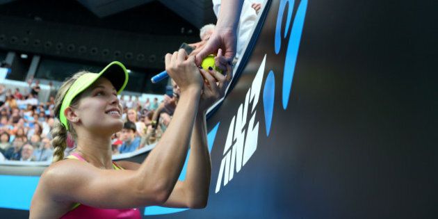 MELBOURNE, AUSTRALIA - JANUARY 21: Eugenie Bouchard of Canada signs autographs after winning her second round match against Kiki Bertens of the Netherlands during day three of the 2015 Australian Open at Melbourne Park on January 21, 2015 in Melbourne, Australia. (Photo by Quinn Rooney/Getty Images)