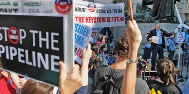 Mike Tidwell, from the Chesapeake Climate Action Network (CCAN), right, addresses a rally outside the Ronald Reagan Building in Washington, Friday, Oct., 7, 2011, against the proposed Keystone XL pipeline. The group is hoping to raise concern on the controversial proposed pipeline by Canadian company TransCanada which would bring as much as 900,000 barrels per day to the US. (AP Photo/Pablo Martinez Monsivais)