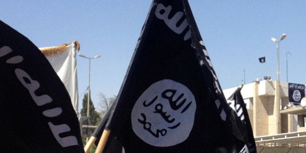 Demonstrators chant pro-al-Qaida-inspired Islamic State of Iraq and the Levant slogans as they wave al-Qaida flags in front of the provincial government headquarters in Mosul, 225 miles (360 kilometers) northwest of Baghdad, Iraq, Monday, June 16, 2014. Sunni militants captured a key northern Iraqi town along the highway to Syria early on Monday, compounding the woes of Iraq's Shiite-led government a week after it lost a vast swath of territory to the insurgents in the country's north. (AP Photo)