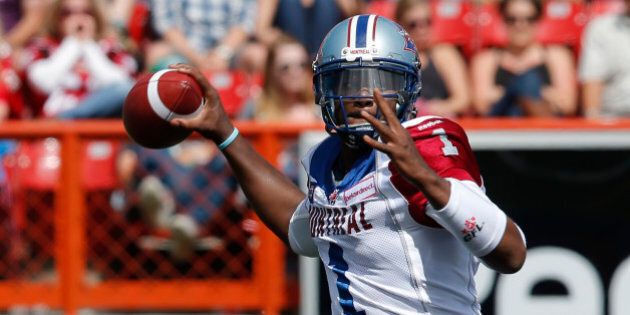 CALGARY, AB - JUNE 28: Quarterback Troy Smith #1 of the Montreal Alouettes throws a pass against the Calgary Stampders in the second half of their CFL football game at McMahon Stadium June 28, 2014 in Calgary, Alberta, Canada. (Photo by Todd Korol/Getty Images)