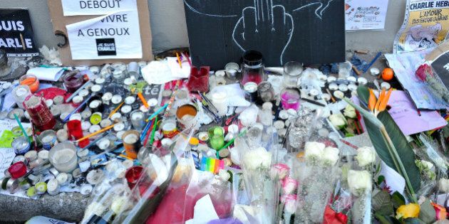 PARIS, FRANCE - JANUARY 14: Tributes of drawings, flowers, pens and candles are left near the Charlie Hebdo offices on January 14, 2015 in Paris, France. Released today, an initial three million copies of the controversial magazine Charlie Hebdo were printed in the wake of last weeks terrorist attacks with an additional two million copies of the magazine scheduled to be printed. (Photo by Kristy Sparow/Getty Images)