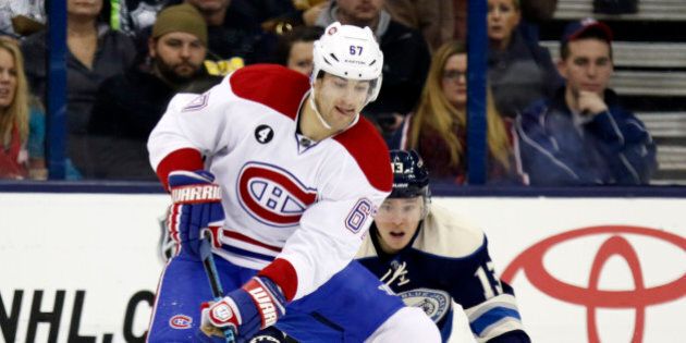 Montreal Canadiens' Max Pacioretty, left, works against Columbus Blue Jackets' Cam Atkinson during the second period of an NHL hockey game in Columbus, Ohio, Wednesday, Jan. 14, 2015. Montreal won 3-2. (AP Photo/Paul Vernon)