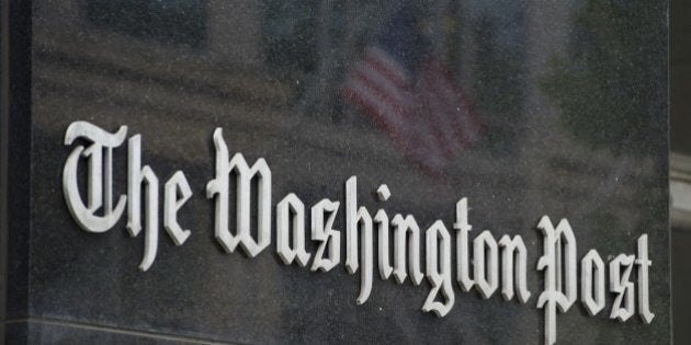 A sign hangs on the outside of the Washington Post Building August 6, 2013 in Washington, DC, the day after it was announced that Amazon.com founder and CEO Jeff Bezos had agreed to purchase the newspaper for USD 250 million. Multi-billionaire Bezos, who created Amazon, which has soared in a few years to a dominant position in online retailing, said he was buying the Post in his personal capacity and hoped to shepherd it through the evolution away from traditional newsprint. AFP PHOTO / Saul LOEB (Photo credit should read SAUL LOEB/AFP/Getty Images)