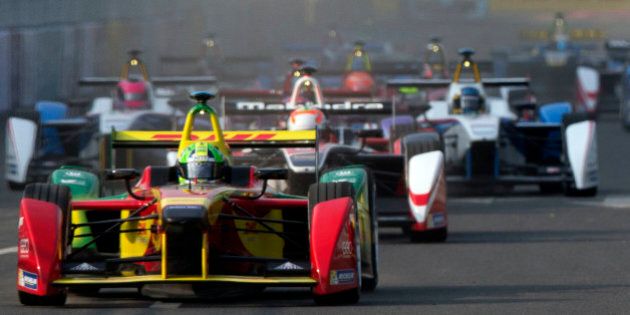 Audi Sport ABT's Lucas di Grassi of Brazil races ahead at the start of the inaugural Formula E all-electric auto race in Beijing Saturday, Sept. 13, 2014. Di Grassi crossed the finish line first to win the event.(AP Photo/Ng Han Guan)