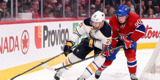 MONTREAL, QC - FEBRUARY 3: Christian Thomas #60 of the Montreal Canadiens battles for the puck against Drew Stafford #21 of the Buffalo Sabres in the NHL game at the Bell Centre on February 3, 2015 in Montreal, Quebec, Canada. (Photo by Francois Lacasse/NHLI via Getty Images)