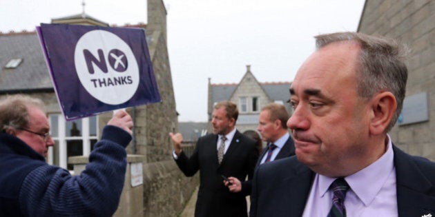 Scotland's First Minister Alex Salmond, looks on at a No campaigner during a walkabout in Ellon, Scotland, Thursday, Sept. 18, 2014. From the capital of Edinburgh to the far-flung Shetland Islands, Scots embraced a historic moment - and the rest of the United Kingdom held its breath - after voters turned out in unprecedented numbers for an independence referendum that could end the country's 307-year union with England. (AP Photo/Scott Heppell)