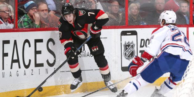 OTTAWA, ON - JANUARY 15: Kyle Turris #7 of the Ottawa Senators stickhandles the puck along the corner boards against Nathan Beaulieu #28 of the Montreal Canadiens at Canadian Tire Centre on January 15, 2015 in Ottawa, Ontario, Canada. (Photo by Andre Ringuette/NHLI via Getty Images)