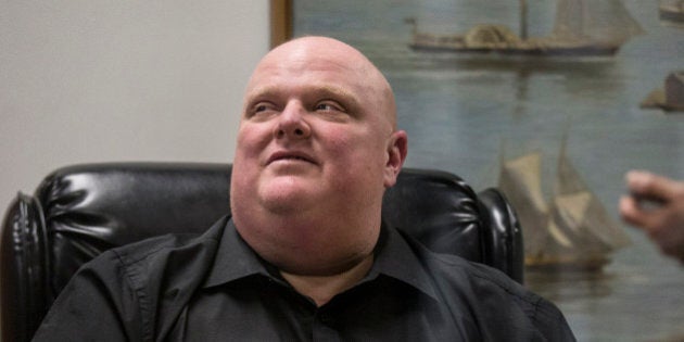 TORONTO, ON - NOVEMBER 21: Rob Ford sits in the reception area of his office to sign bobble heads. Lineups started early in the morning of public wanting to buy the bobble heads. (Bernard Weil/Toronto Star via Getty Images)