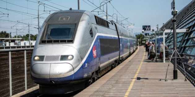 Passengers wait to board a TGV duplex high-speed train, operated by Societe Nationale des Chemins de Fer (SNCF) and manufactured by Alstom SA, as it stands in the railway station at Gare d'Avignon in Avignon, France, on Thursday, June 19, 2014. Siemens AG's plan had also envisioned merging the train operations of Siemens and Alstom and the Germany company said today it's now also offering an immediate rail-signaling joint venture with the French rival. Photographer: Balint Porneczi/Bloomberg via Getty Images