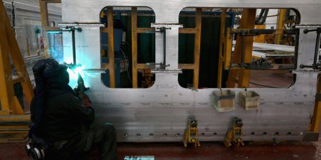 DERBY, ENGLAND - JULY 16: Technicians work on London Underground trains at the Bombardier Transport manufacturing plant on July 16, 2014 in Derby, England. The train maker Bombardier build rolling stock for both mainline train operations and London Underground. Currently they are building the latest consignment of carriages for the London Crossrail project. (Photo by Christopher Furlong/Getty Images)