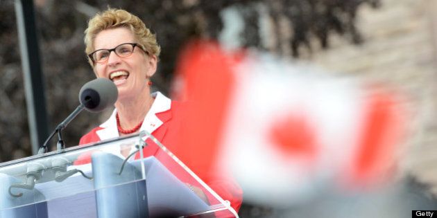 TORONTO, ON - JULY 1: Ontario Premier Kathleen Wynne and Honourable Michael Coteau , Minister of Citizenship and Immigration(black man in backround) greets the crowd on Canada's Day at Queens Park. (Vince Talotta/Toronto Star via Getty Images)