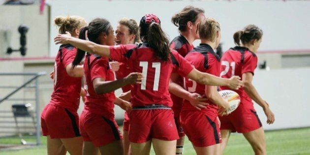 Canadian players celebrate after Magali Harvey, second from left, scored the second try for her team, during the semi final match of the Women's Rugby World Cup 2014 between France and Canada, at Jean Bouin stadium, in Paris, Wednesday, Aug. 13, 2014. Canada won 18-16 and will play against England in the final on Sunday. (AP Photo/Remy de la Mauviniere)