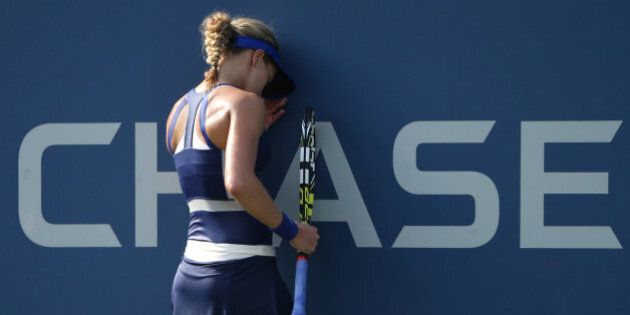 Eugenie Bouchard, of Canada, reacts after a shot against Ekaterina Makarova, of Russia, during the fourth round of the 2014 U.S. Open tennis tournament, Monday, Sept. 1, 2014, in New York. (AP Photo/John Minchillo)