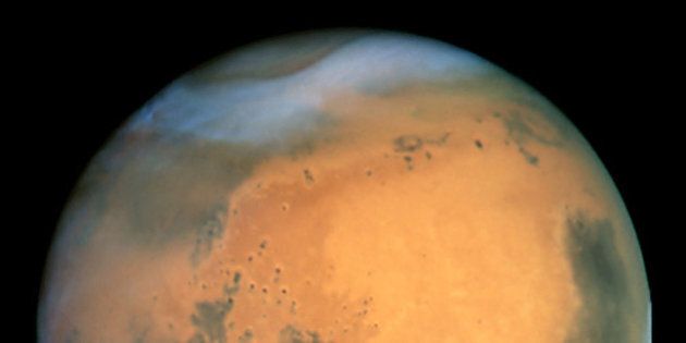 MANDATORY CREDIT: NASA Hubble Space Telescope. Undated handout view taken by the NASA Hubble Space Telescope of the planet Mars, which passes closer to the Earth this week than it has at any time in almost 60,000 years. The precise time of closest approach will be 9.51am on Wednesday August 27 2003, when a mere 34,646,418 miles will separate the Earth and Mars - 145 times the distance to the Moon. Already it is impossible to miss the planet, a fiery yellow-orange disc in the south-eastern sky that far outshines the brightest star, Sirius. The event is a big occasion for amateur astronomers, who will have to wait 284 years for Mars to come as near again. See PA story SCIENCE MArs. PA Photo. NASA Hubble Space Telescope.