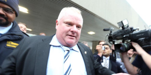 TORONTO, ON - MARCH 19 - Mayor Rob Ford leaves City Hall with London Times food critic Giles Coren and his film crew and visits a food truck on Queen St with media surrounding him and the crew all the way back through Nathan Phillips Square to City Hall. Toronto, March 19, 2014. (Vince Talotta/Toronto Star via Getty Images)