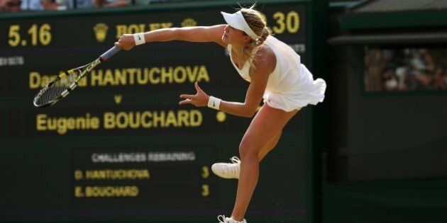 Canada's Eugenie Bouchard serves to Slovakia's Daniela Hantuchova during their women's singles first round match on day two of the 2014 Wimbledon Championships at The All England Tennis Club in Wimbledon, southwest London, on June 24, 2014. AFP PHOTO / ANDREW YATES - RESTRICTED TO EDITORIAL USE (Photo credit should read ANDREW YATES/AFP/Getty Images)